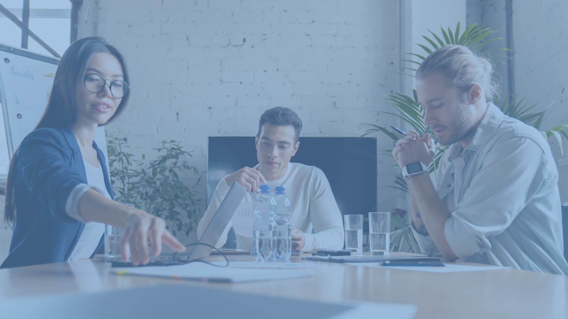 women and men on a meeting table